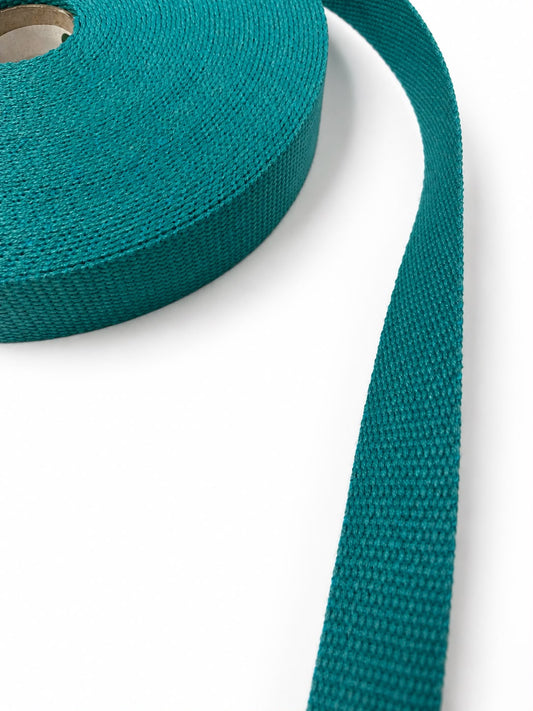 Rollo de cinta de algodón azul petróleo con textura tejida