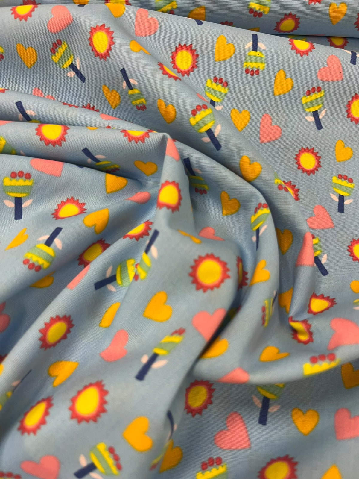 Algodón Estampado Sol y Corazón Azul - detalle cara y escala motivos